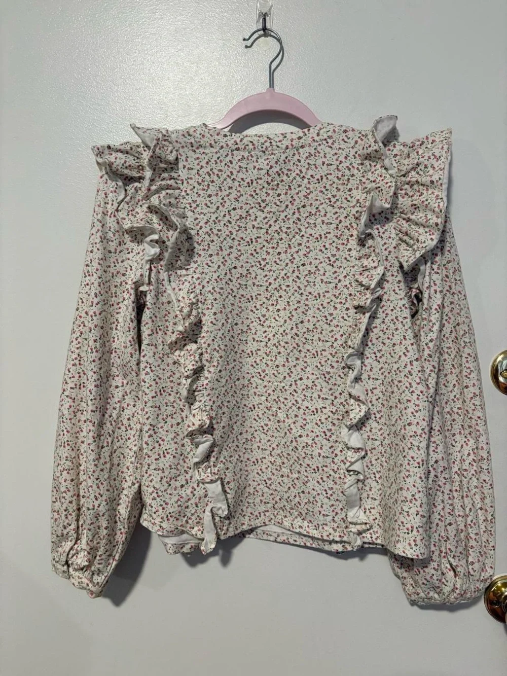 Anthropologie white cotton blouse with small pink ditzy floral print and ruffles
